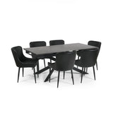 Extended black dining table with six black leather chairs, viewed from an angle on white background.