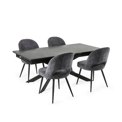 Extended black dining table with six grey velvet chairs arranged neatly on white background.