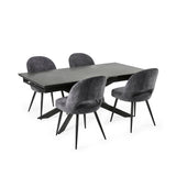 Extended black dining table with six grey velvet chairs arranged neatly on white background.