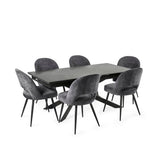 Modern black extending dining table with six grey velvet chairs in a grey-themed room setting.