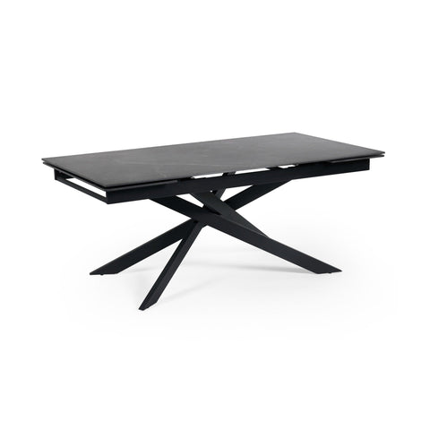 Rectangular matte black extending dining table with crossed metal base, isolated on white background