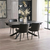 Black rectangular dining table with black leather chairs, light wood floor, modern room setting