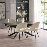 Close-up of black extending dining table with light beige fabric chairs on light wood floor
