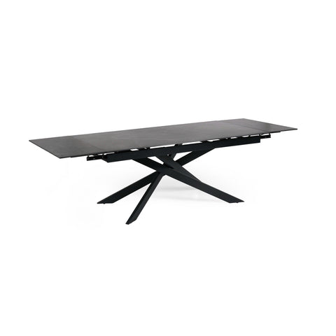 Extended matte black dining table with crossed metal base, isolated on white background, side view