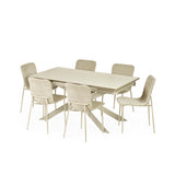 Light beige dining table with six cream upholstered chairs shown from side on white background