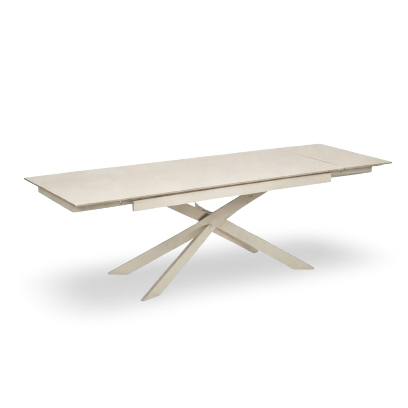 Light beige extending dining table fully extended with crossed cream metal legs on white background