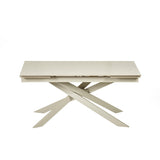 Front view of closed extending dining table with cream crossed metal legs against a white background