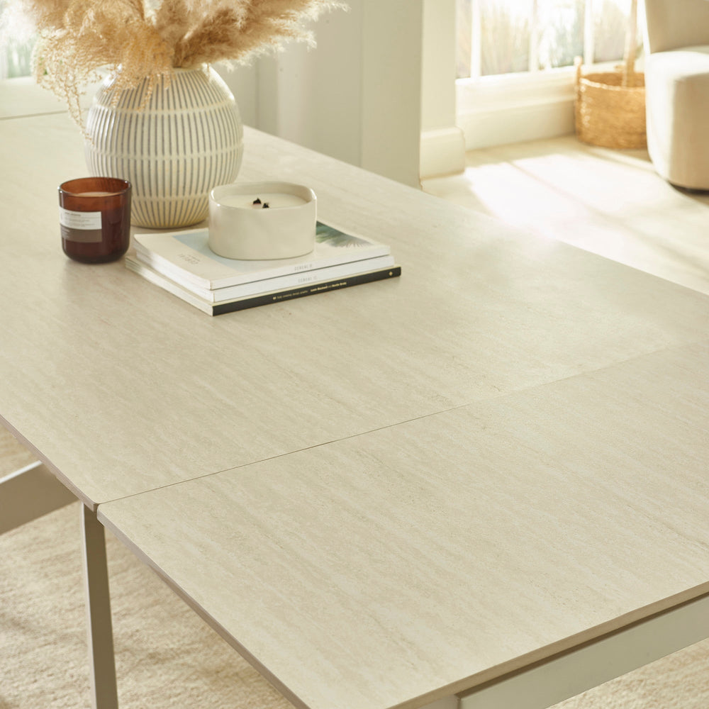 Close-up showing light beige textured tabletop with clean straight edge and slight opening for extender