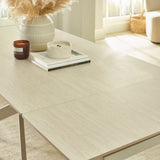 Close-up showing light beige textured tabletop with clean straight edge and slight opening for extender