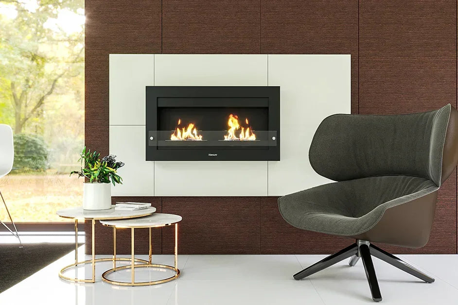 Modern wall-mounted fireplace with flames, grey accent chair, and round side table in living room