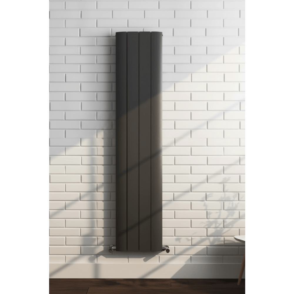 Black radiator on a white brick wall