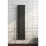 Black radiator on a white brick wall