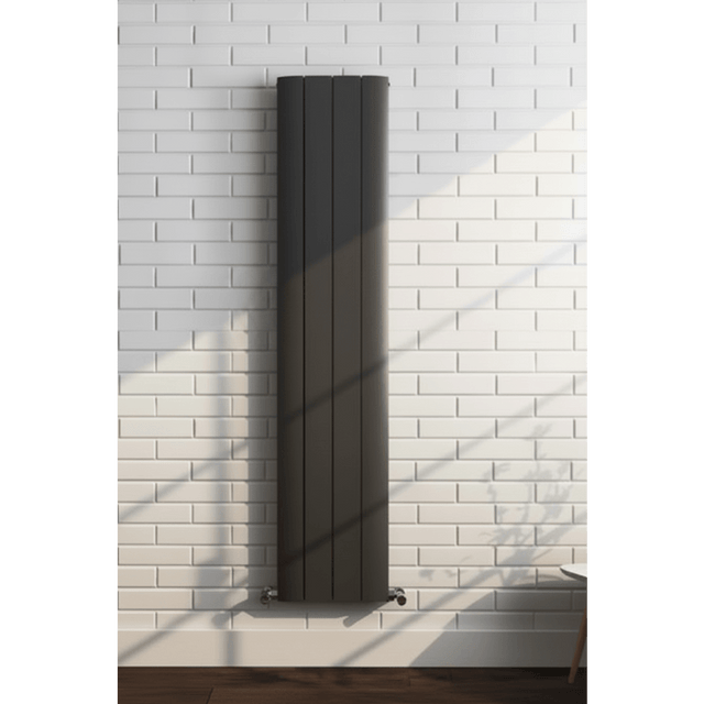 Black radiator on a white brick wall