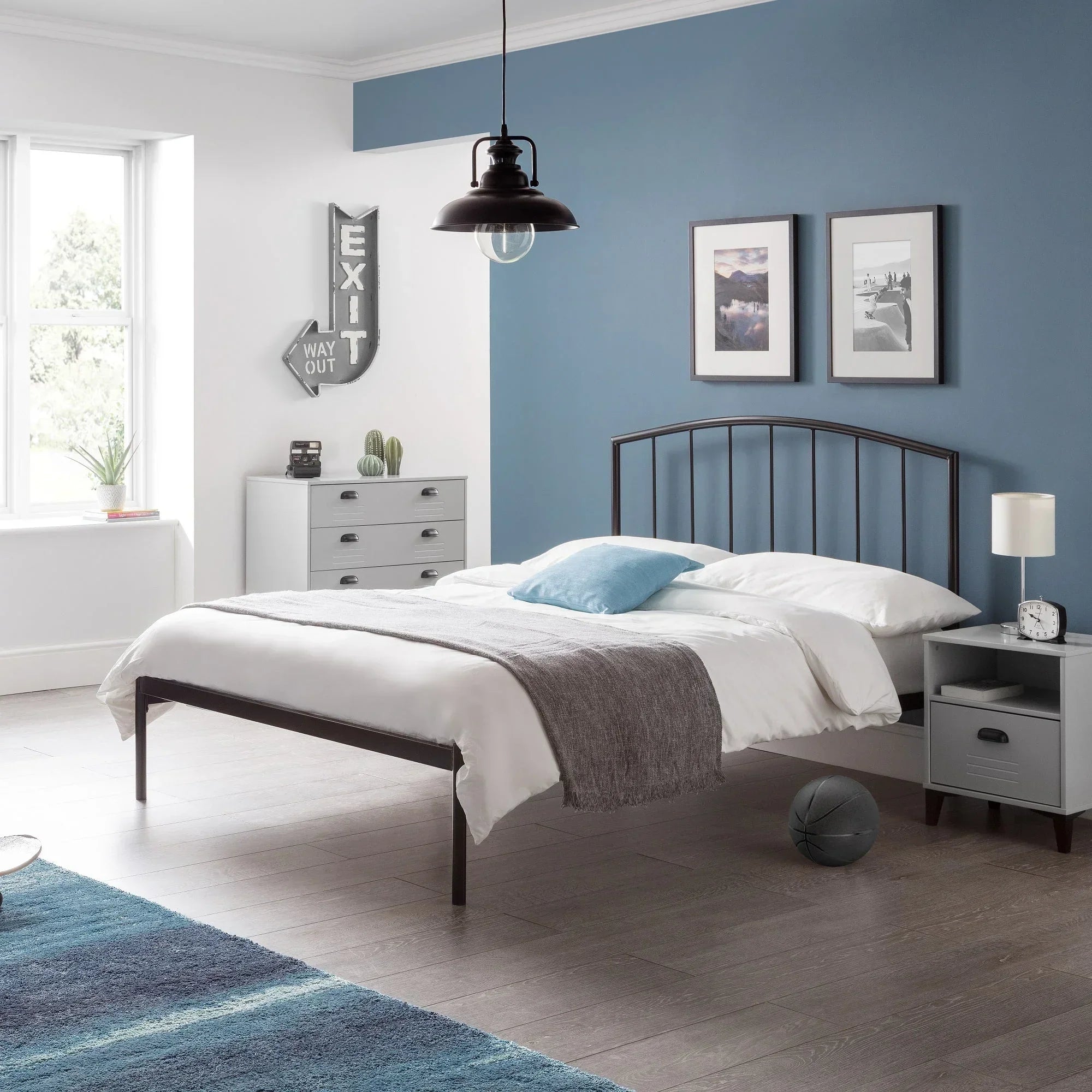 Onyx bed frame with white bedding and metal headboard in modern blue and grey bedroom