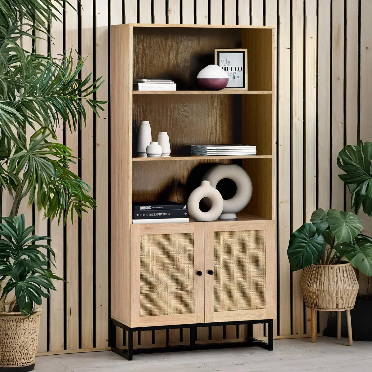 Wooden display cabinet with cane doors, open shelves, and decorative vases in modern room