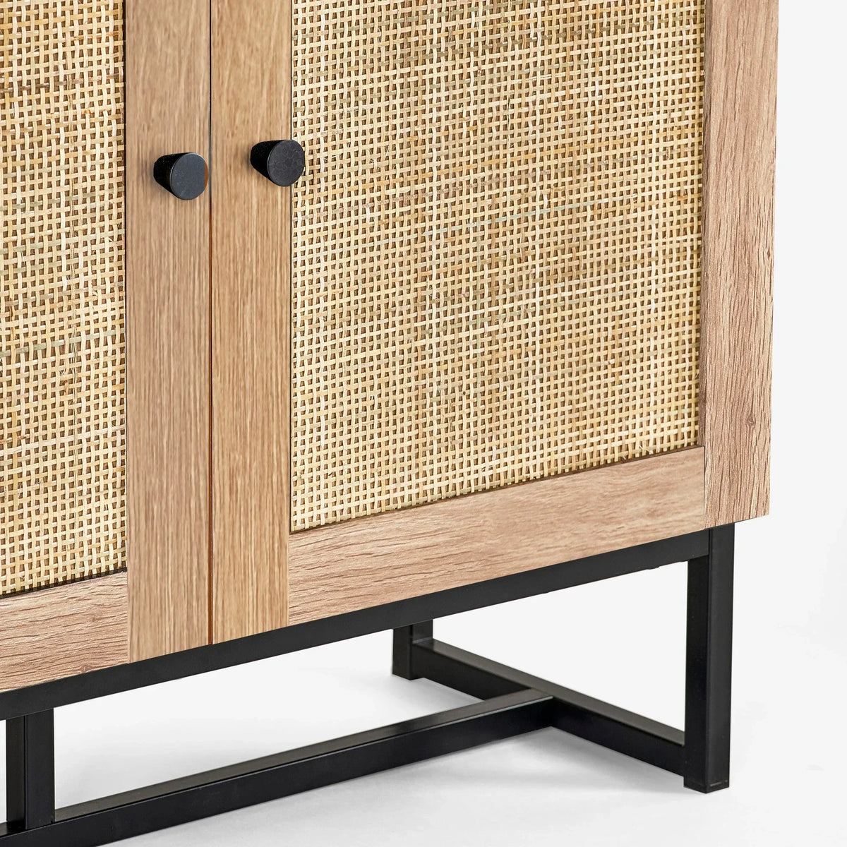 Oak and rattan cabinet with black metal legs, close-up of door knobs and woven panel