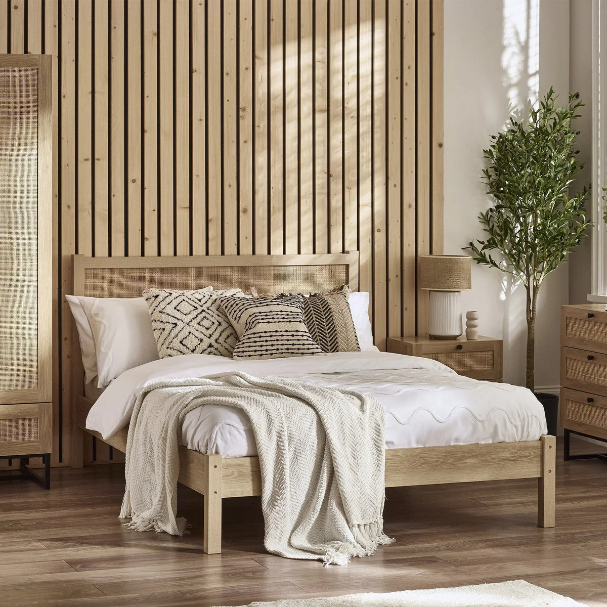 Padstow oak rattan double bed with white bedding in modern bedroom with wood accents