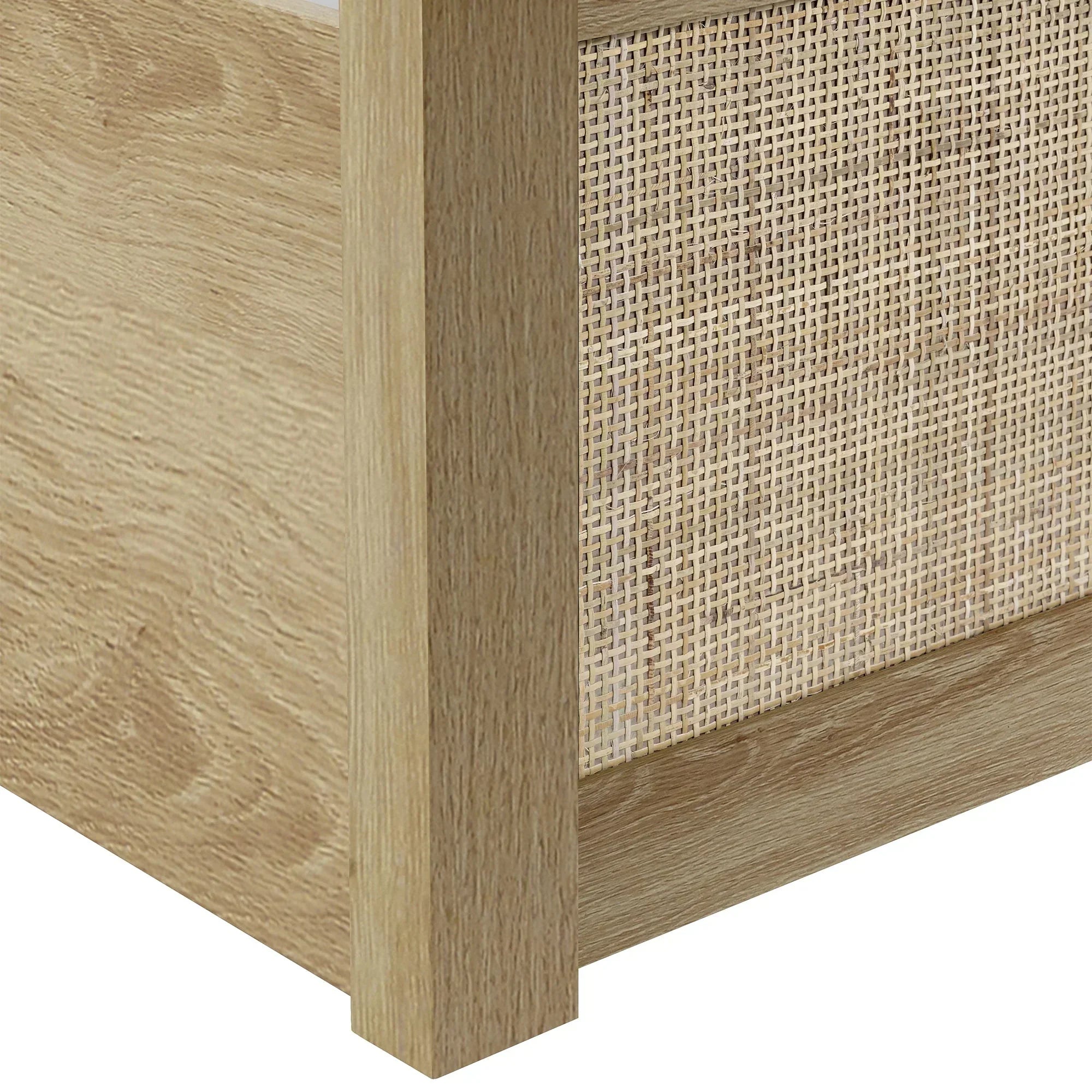 Closeup of oak rattan ottoman bed frame corner showing wood grain and woven panel