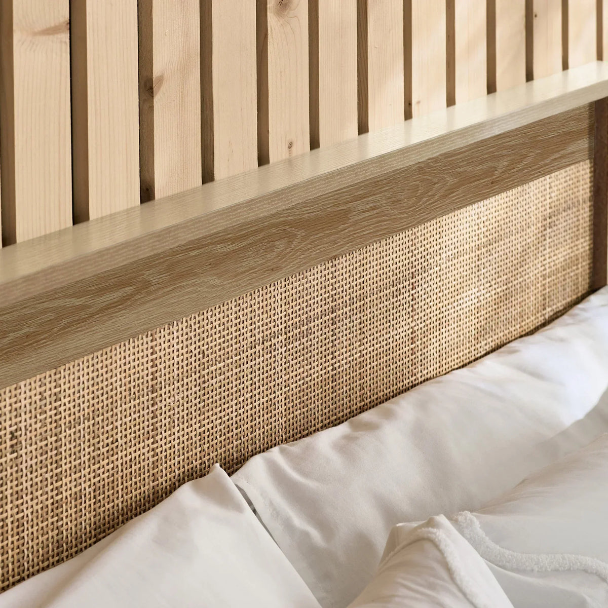 Close up of oak rattan ottoman bed headboard with woven detail and natural wood grain
