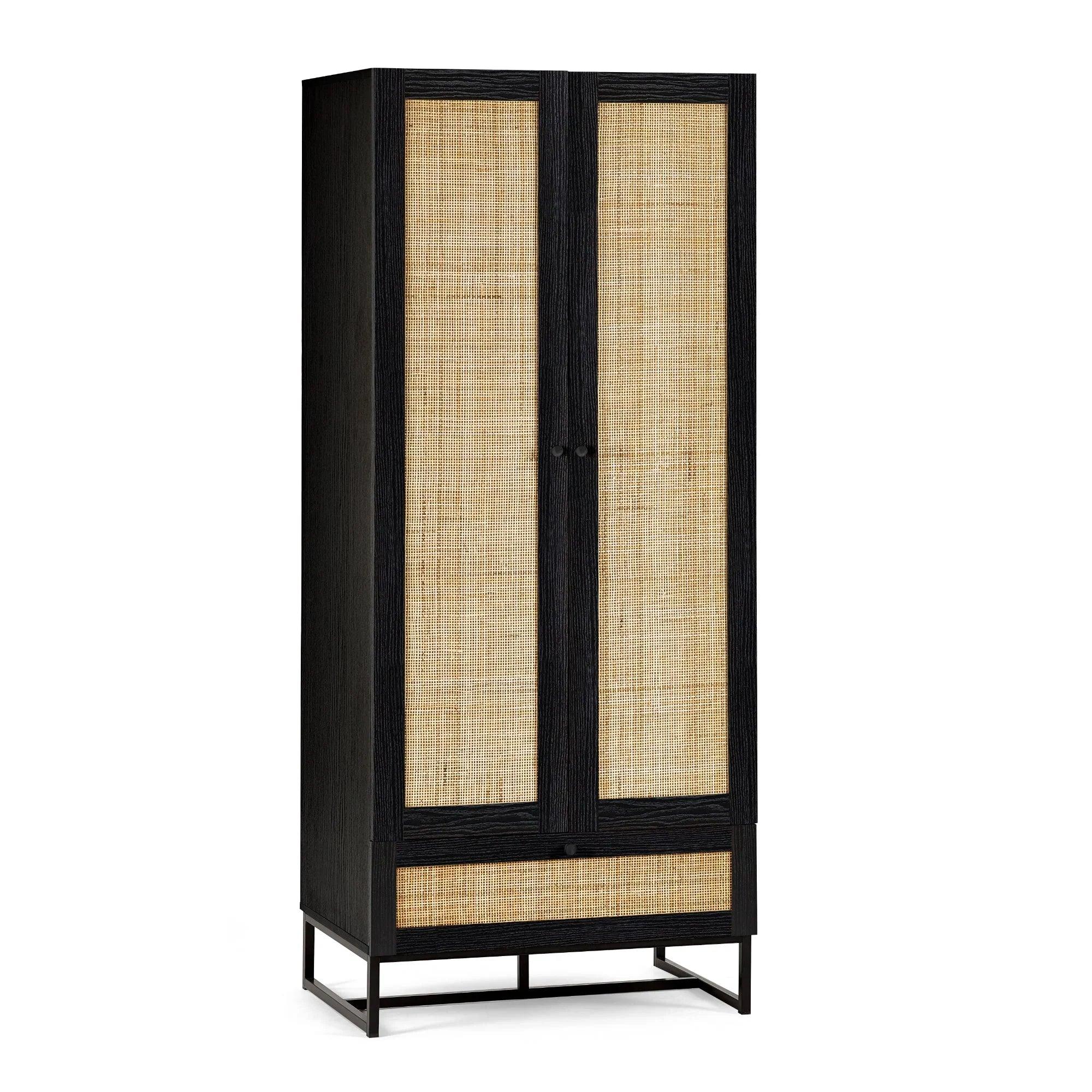 Black wardrobe with rattan doors and base drawer on metal legs, front angle view