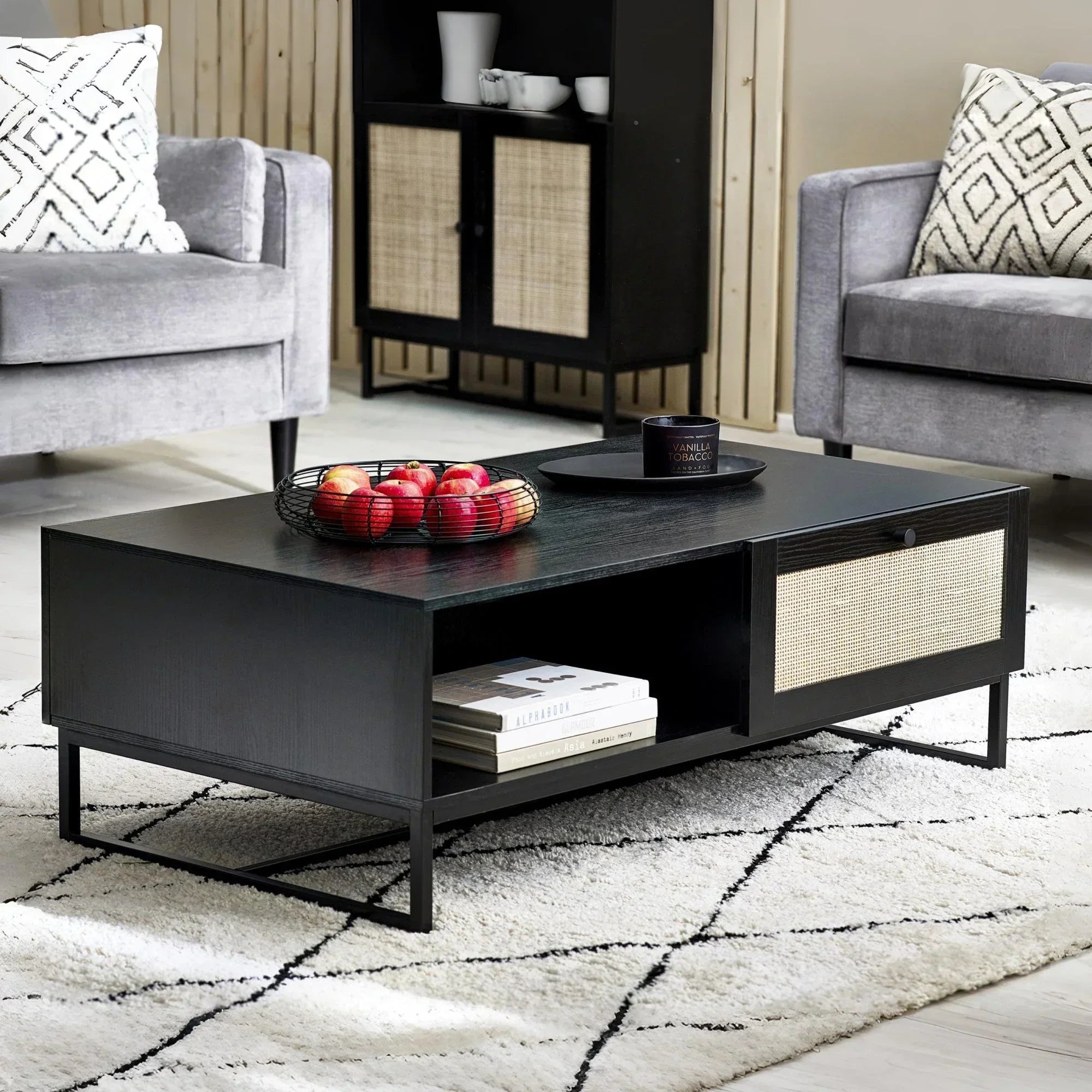 Black wood coffee table with rattan drawer and open shelf in modern living room