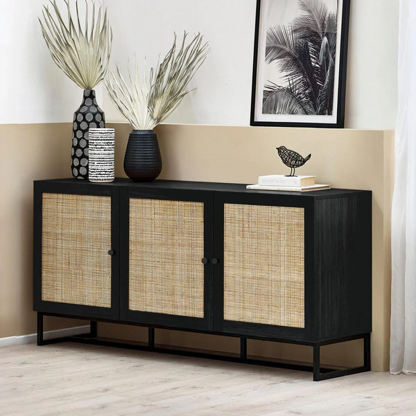 Black sideboard with three rattan doors, decorative vases and artwork on top, modern room