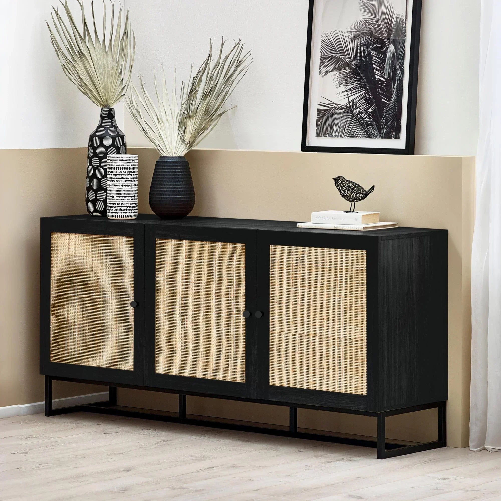 Black sideboard with three rattan doors, decorative vases and artwork on top, modern room