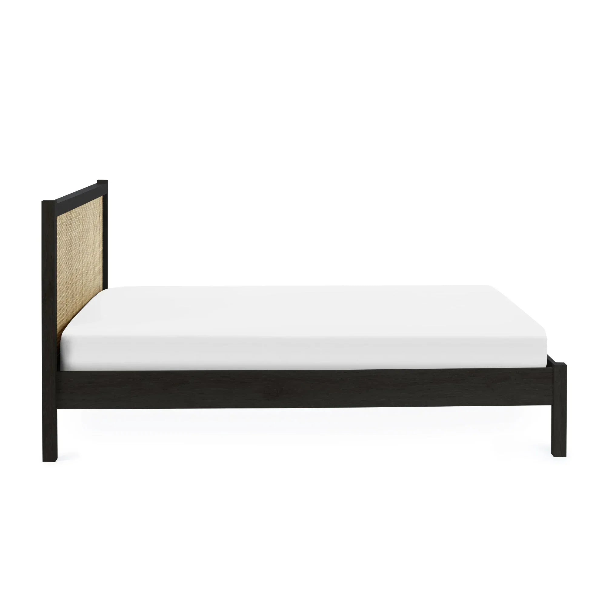 Black rattan double bed frame with natural woven headboard and white mattress, side view