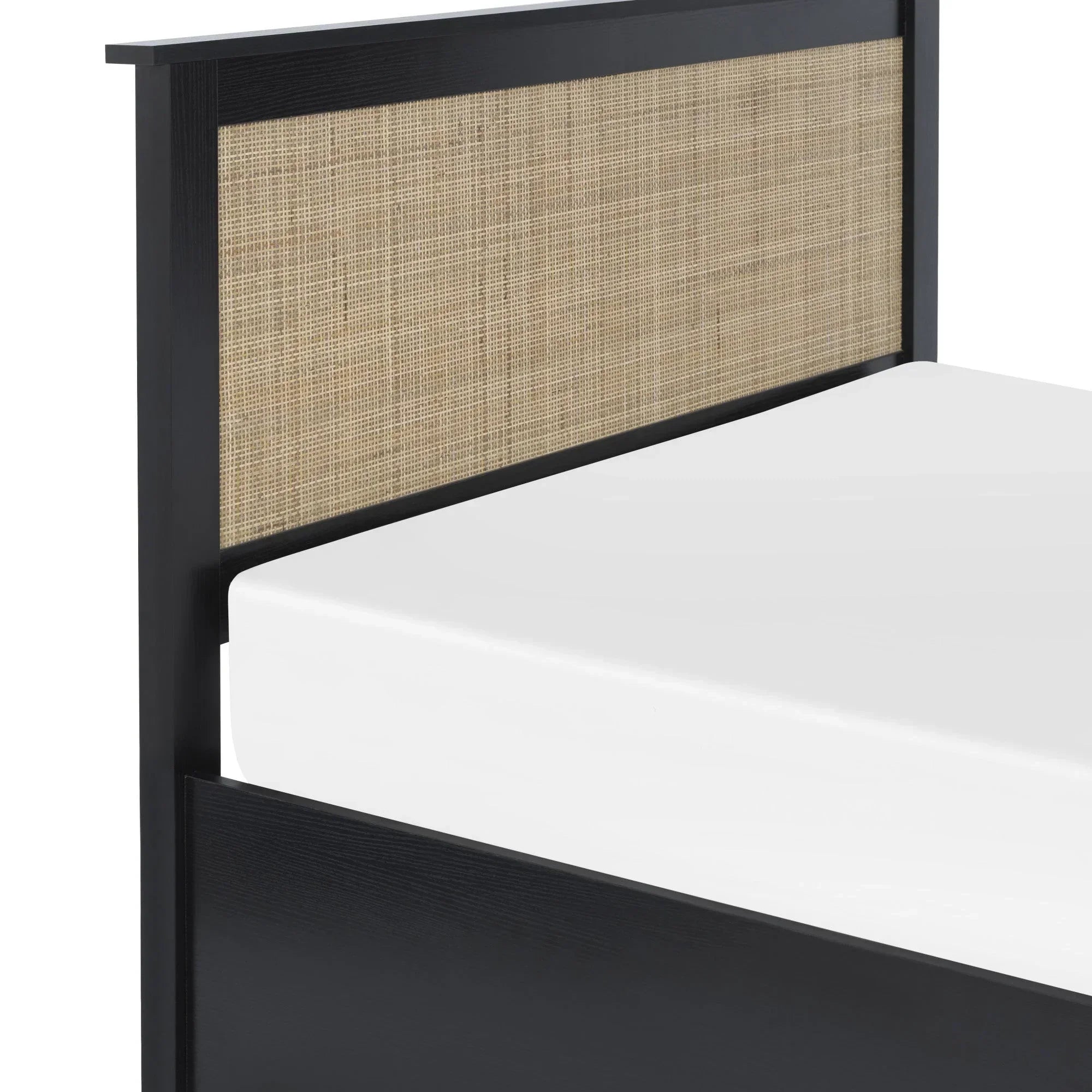 Black rattan ottoman with woven headboard detail and white mattress, close-up angle