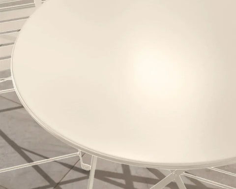 Champagne metal garden bistro table closeup showing smooth round tabletop and frame details