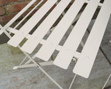 Champagne metal slatted bistro chair close-up on stone patio