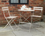 Champagne metal bistro set with round table and two folding chairs on patio