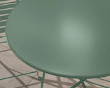 Round olive green metal garden table with matching chair on tiled patio