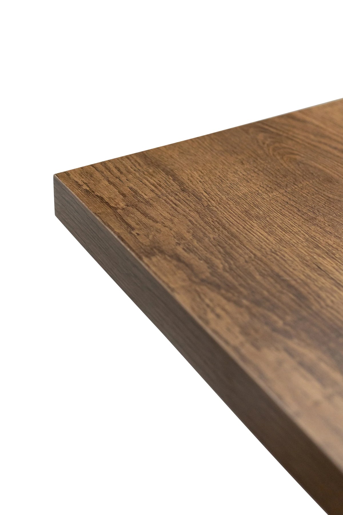 Close up of wooden table top with smooth brown oak finish and clean edge