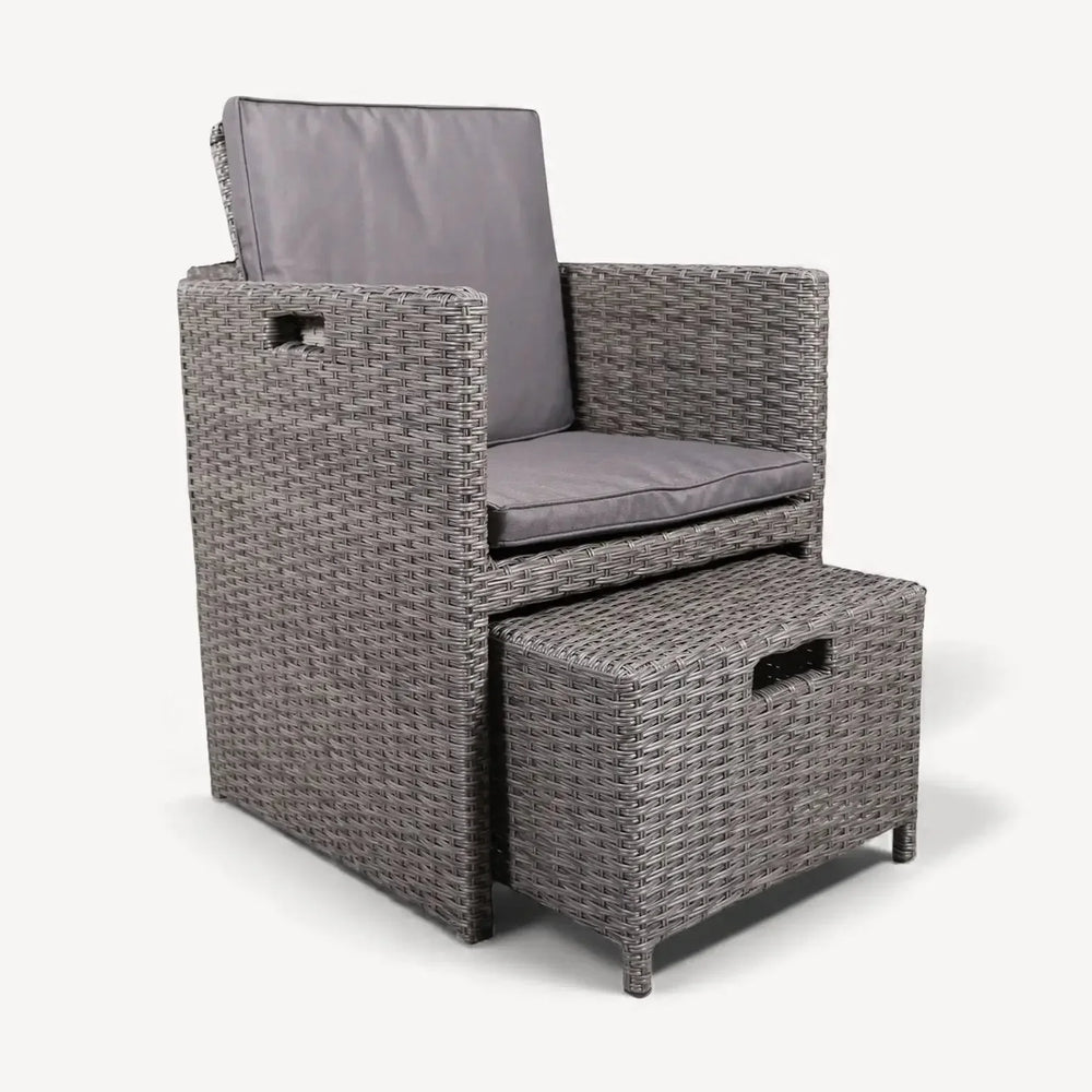 Grey rattan armchair with matching cushioned footstool set on white background
