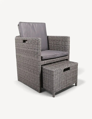 Grey rattan armchair with matching cushioned footstool set on white background