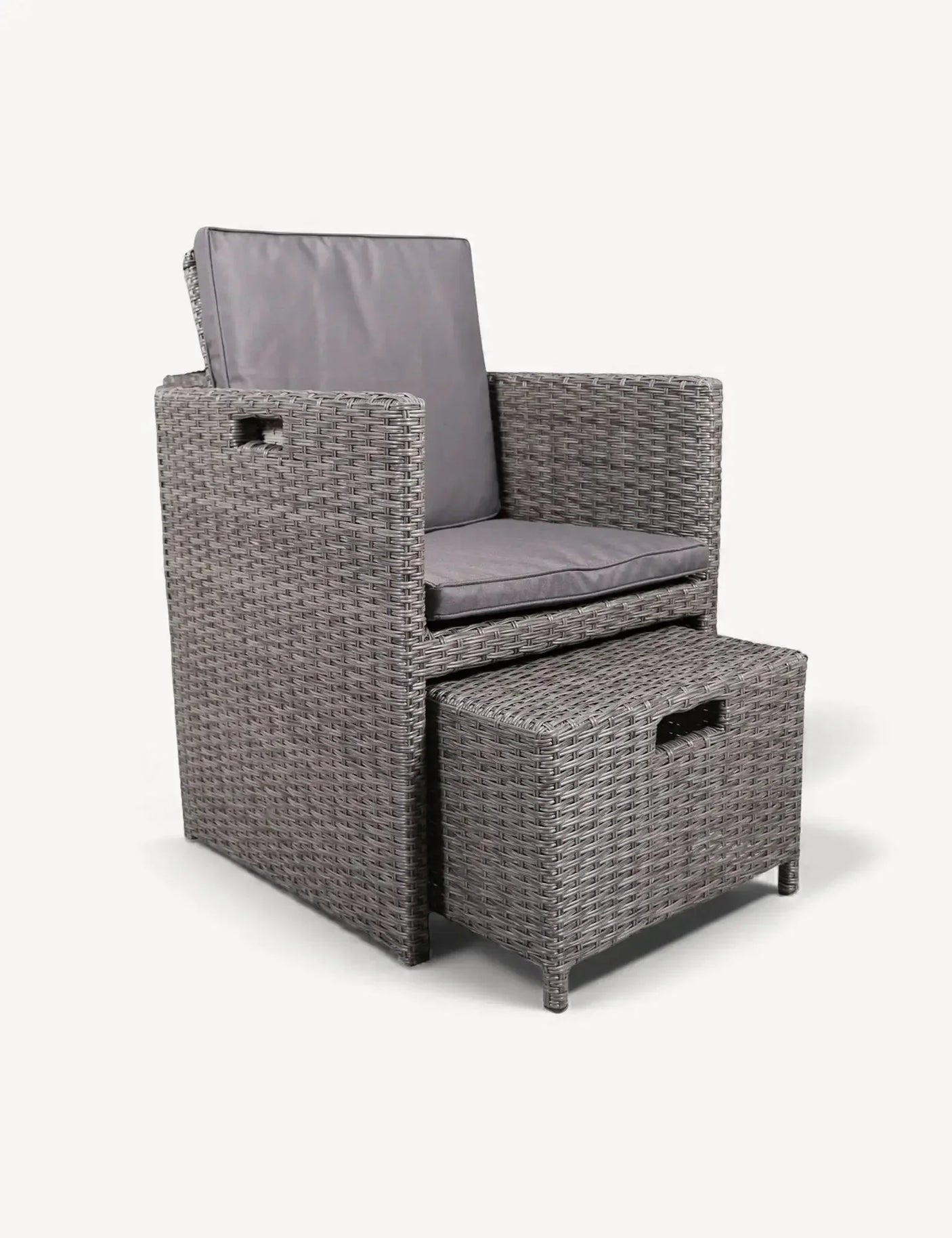 Grey rattan armchair with matching cushioned footstool set on white background