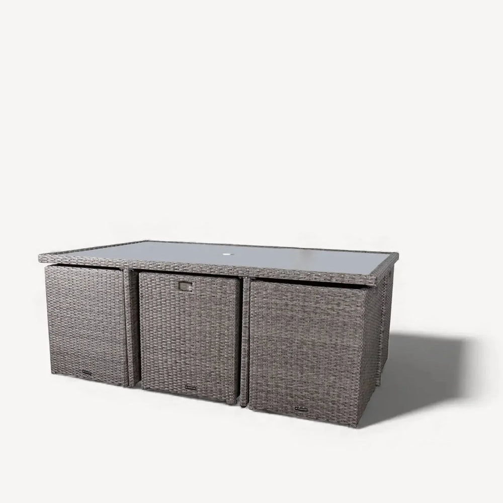 Grey rattan garden dining table with glass top and storage compartments
