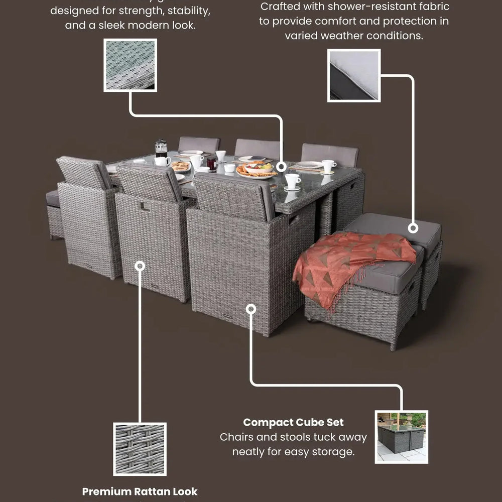 Grey rattan garden dining set with glass table top, weatherproof cushions, and cube storage
