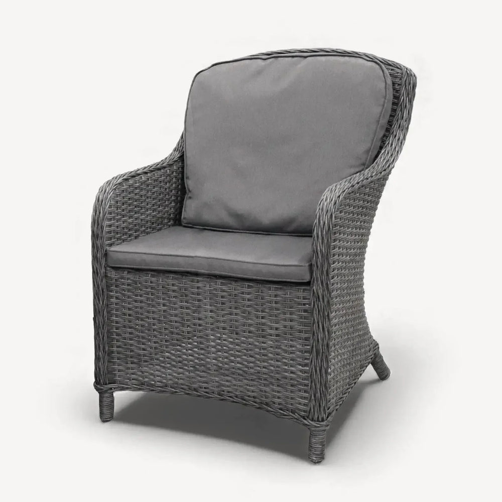 Grey rattan armchair with seat and back cushions, front angle view