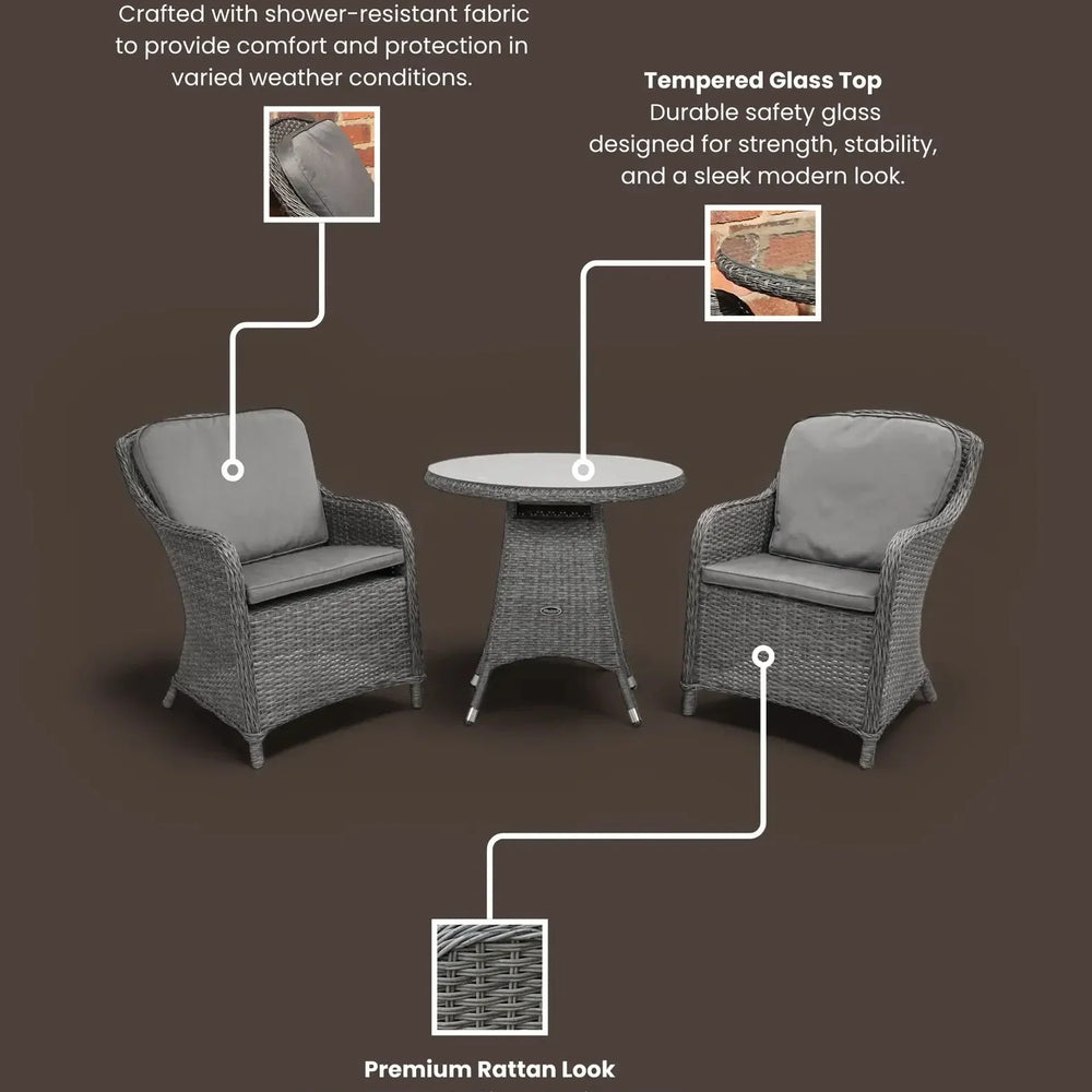 Grey rattan garden bistro set with two cushioned chairs and round tempered glass table