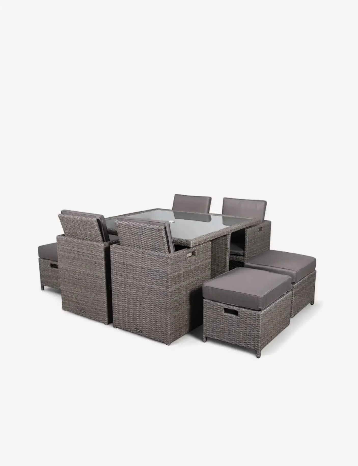 Grey rattan dining set with glass table, cushioned chairs and stools for indoor or outdoor use