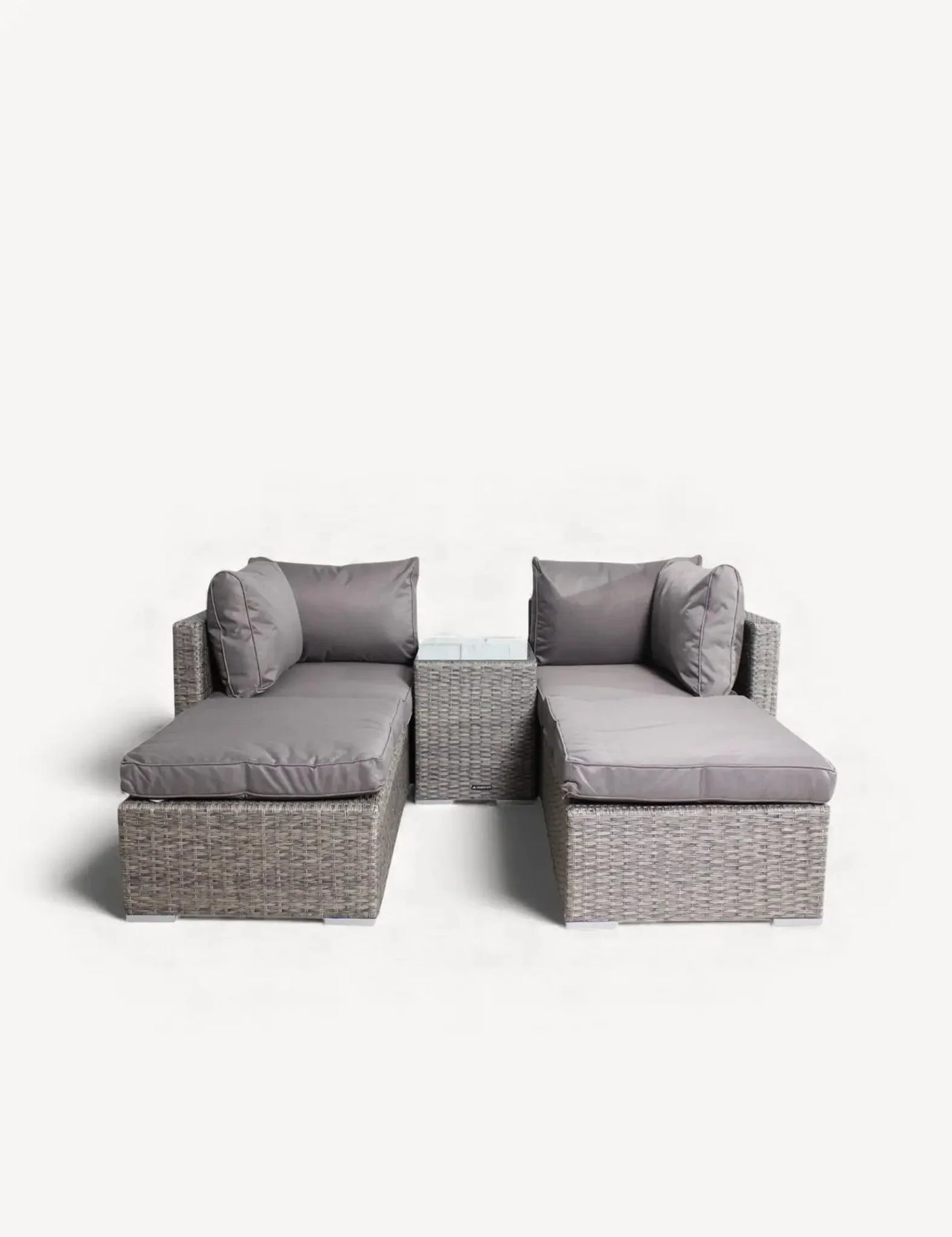 Grey rattan garden sofa set with matching glass-topped side table and plush cushions