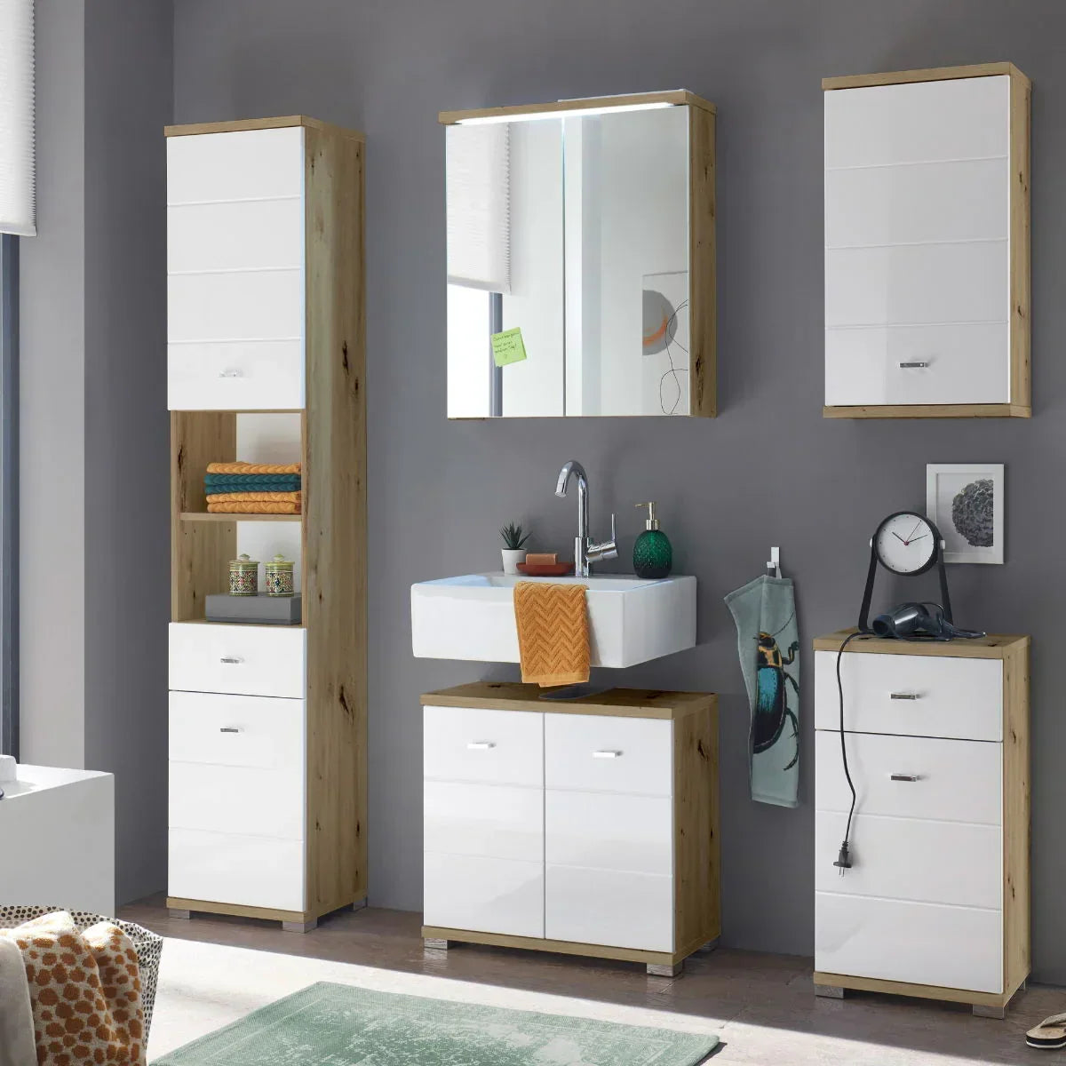 Modern bathroom furniture set with white gloss cabinets and sink on grey wall