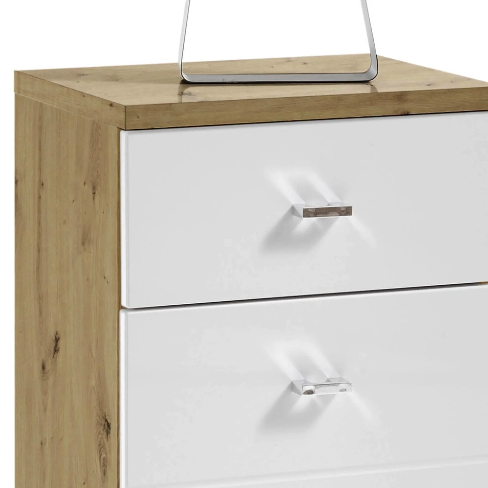 Oak effect and white chest of drawers with metal handles, close-up of upper section
