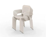 Stacked champagne dining chairs with armrests and perforated backs on white background
