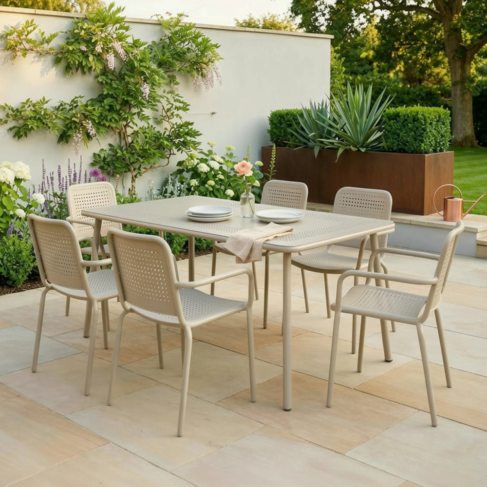 Champagne outdoor dining set with six chairs on tiled patio in garden setting