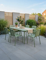 Olive green outdoor dining set with six chairs and rectangular table on patio