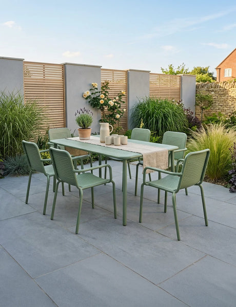 Olive green outdoor dining set with six chairs and rectangular table on patio