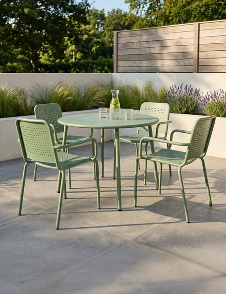 Olive green metal outdoor dining set with round table and four chairs on patio